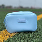 Blue pouch with 'sideline' branding on grass
