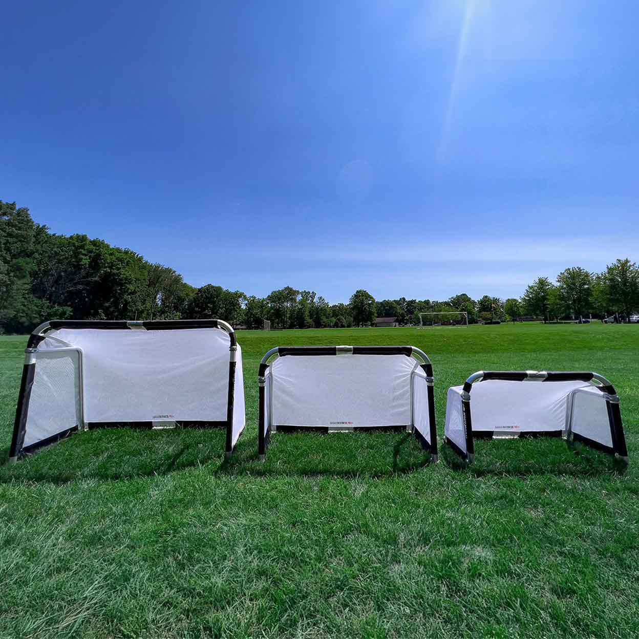 all three sizes of the KwikGoal Goalazo Medium Goal in a field