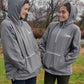 Two girls wearing the USA Field Hockey Unisex Anorak Jacket with their hoods up.