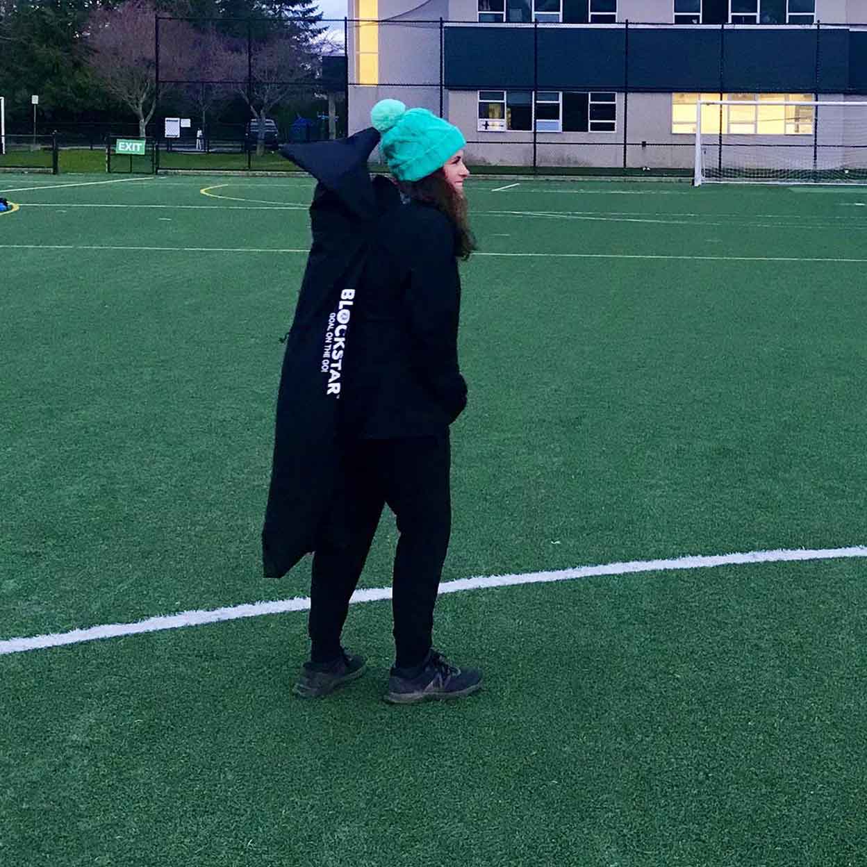 girl on field carrying the Blockstar Goal On The Go in its bag.