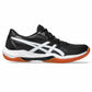 Black and white athletic shoe with orange non-marking sole on a white background