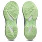 A pair of light mint green athletic shoe soles shown from the bottom against a white background.