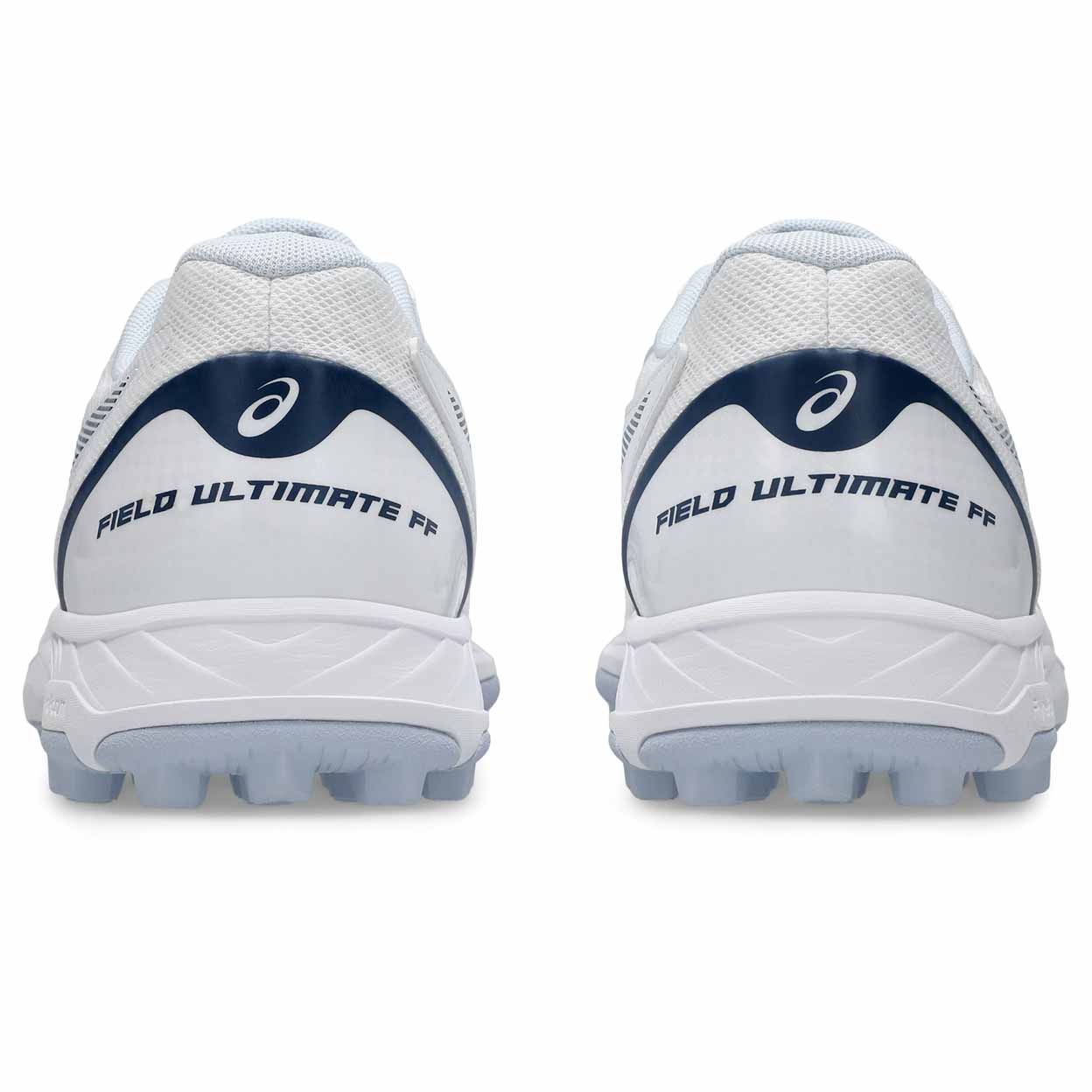 A pair of white Asics Field hockey shoes shown from the rear, featuring navy blue branding and logos on a clean white background.