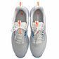 White sneakers with orange and blue accents on a white background