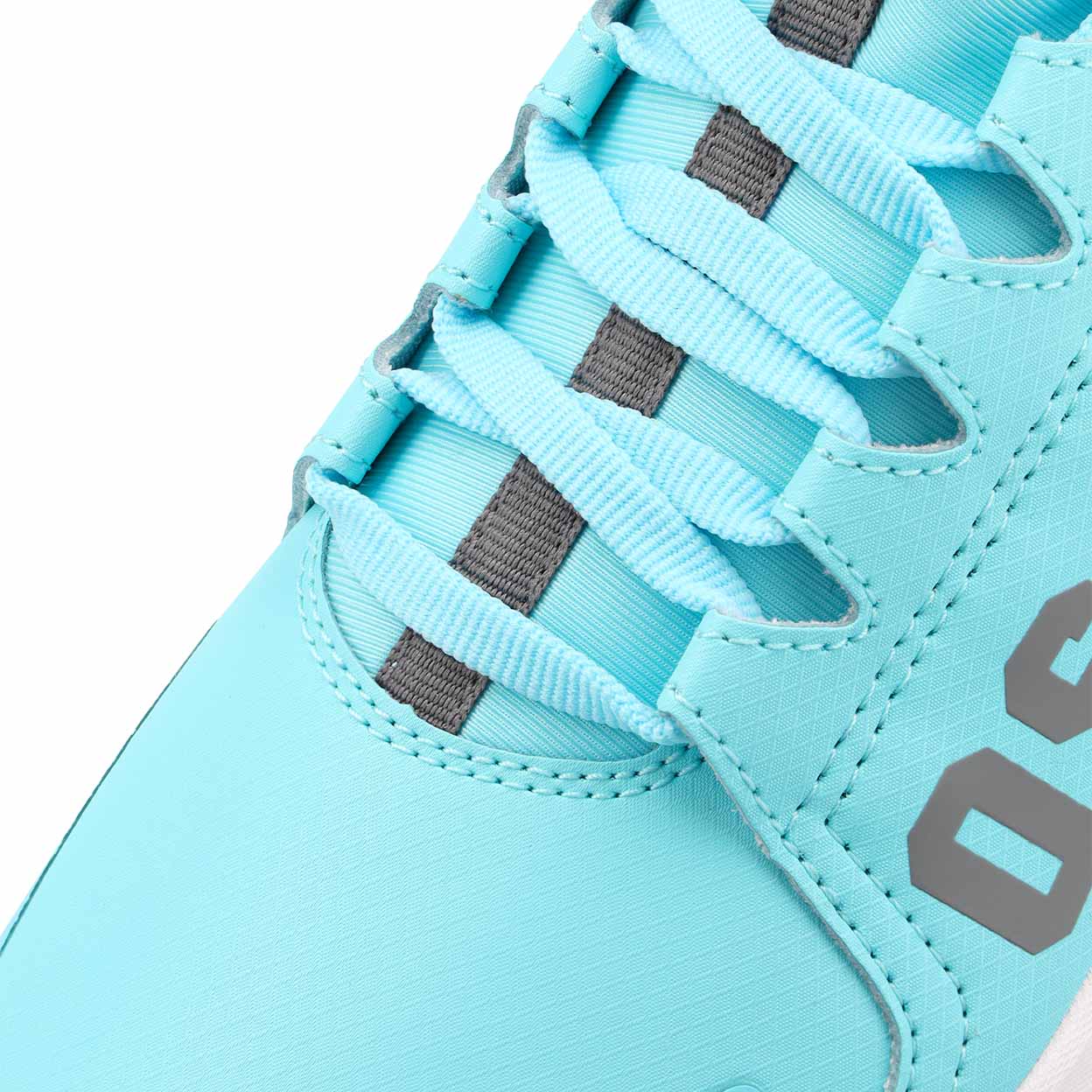 Close-up of a light blue sneaker with gray laces and accents on a white background