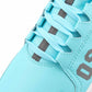 Close-up of a light blue sneaker with gray laces and accents on a white background