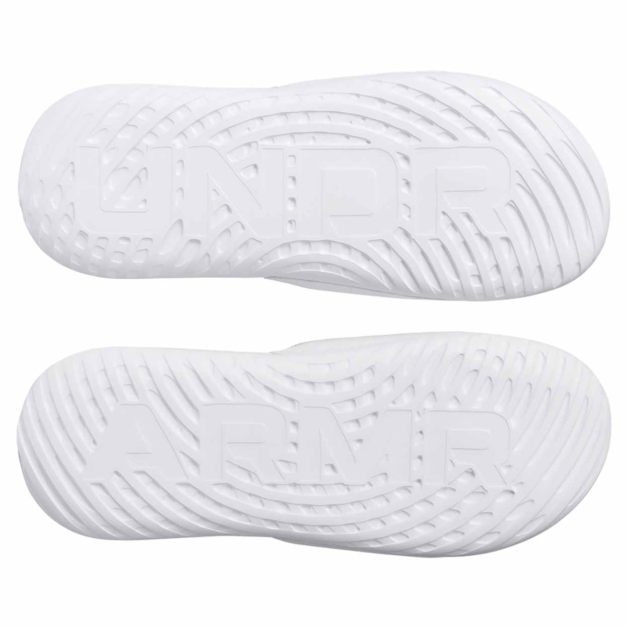 soles of a pair of white Under Armour Women's Ignite Select Slides showing the letters UNDR ARMR on the bottoms.