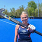 Player Cassie Sumfest holding a Ritual Specialist 95 Field Hockey Stick up in front of herself.