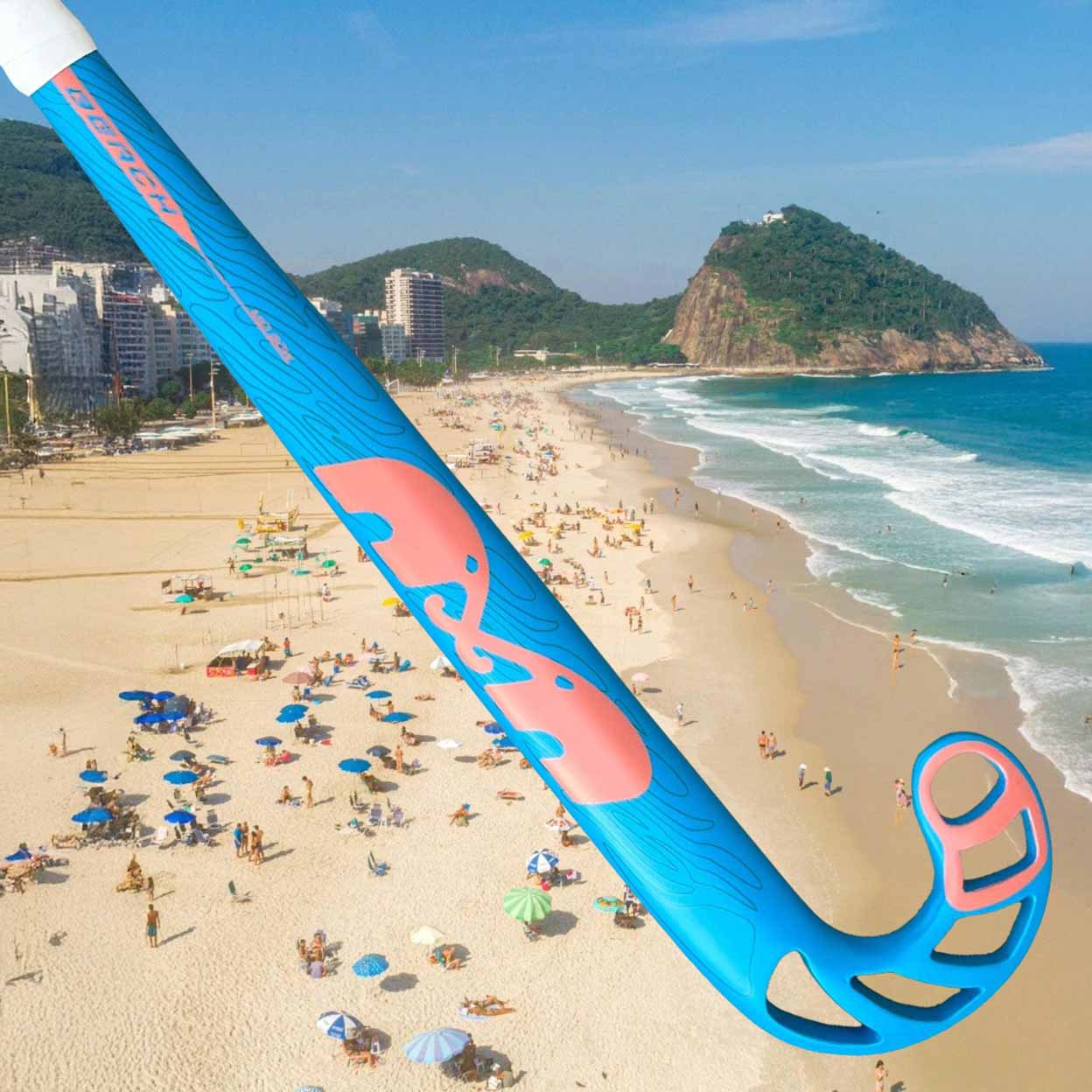 Beach scene with a large blue and pink stick superimposed, people enjoying the beach, and mountains in the background.