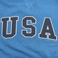 Blue shirt with 'USA' printed in large, white letters on a blue background