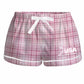 Pink plaid shorts with a white drawstring, white trim, and a USA Field Hockey logo in white on the lower left leg.