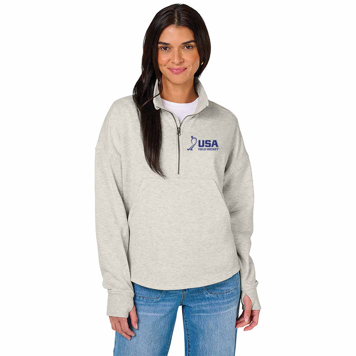 Woman wearing a gray pullover with USA Field Hockey logo on a white background