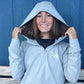 Smiling girl putting the hood up on the USA Field Hockey Quarter Zip Hoodie