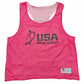 A bright pink mesh athletic training pinnie with 'USA FIELD HOCKEY' printed in black on the front, featuring a size tag in the bottom right corner.