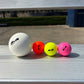 Four balls on a metal bench.