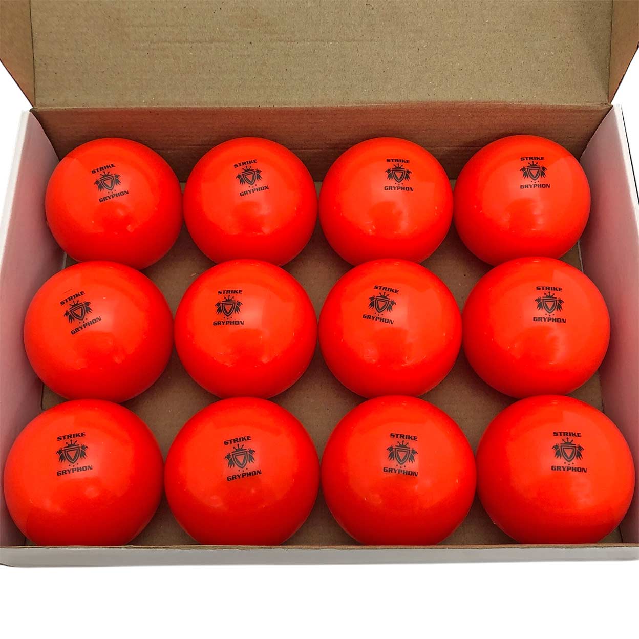 one dozen orange Gryphon Super All-Turf Field Hockey Balls in a box.