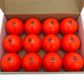 one dozen orange Gryphon Super All-Turf Field Hockey Balls in a box.