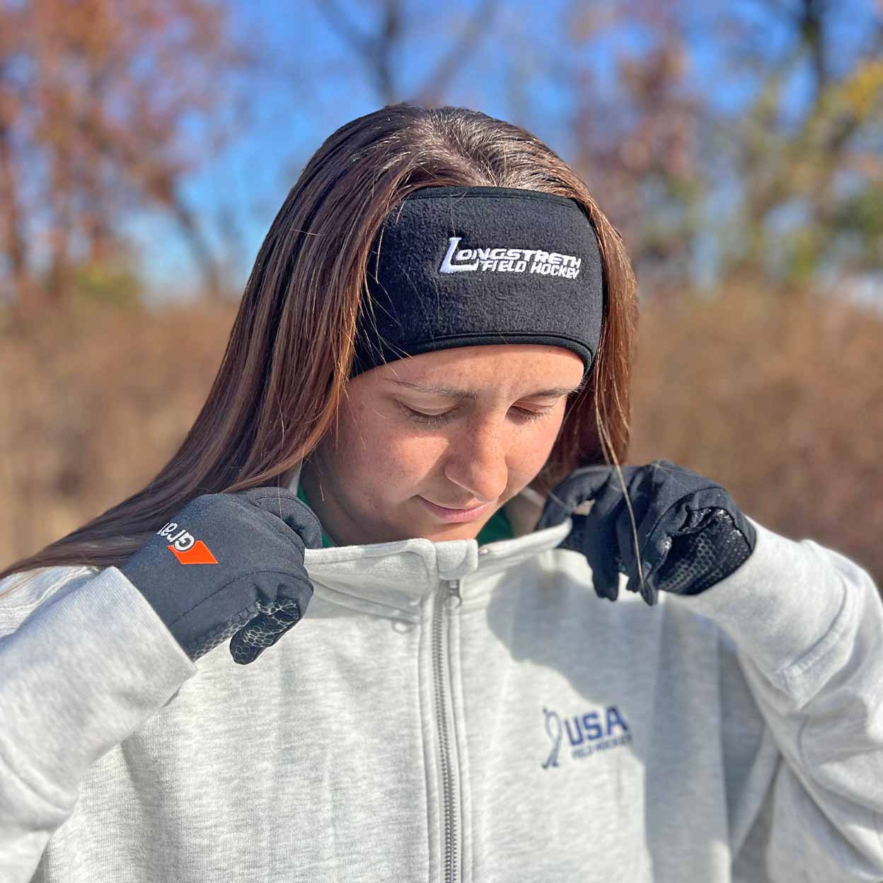 Person wearing a headband with 'Longstreth' branding outdoors