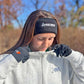 Person wearing a headband with 'Longstreth' branding outdoors