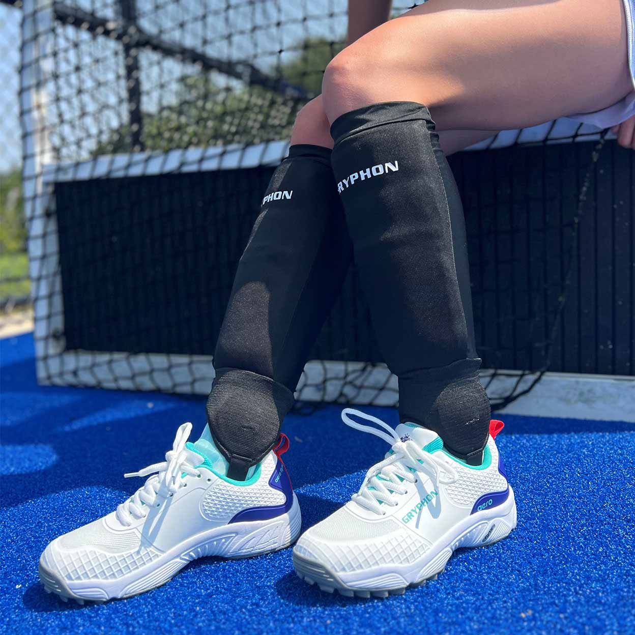 Player wearing the black Gryphon Elite Field Hockey Shinguards