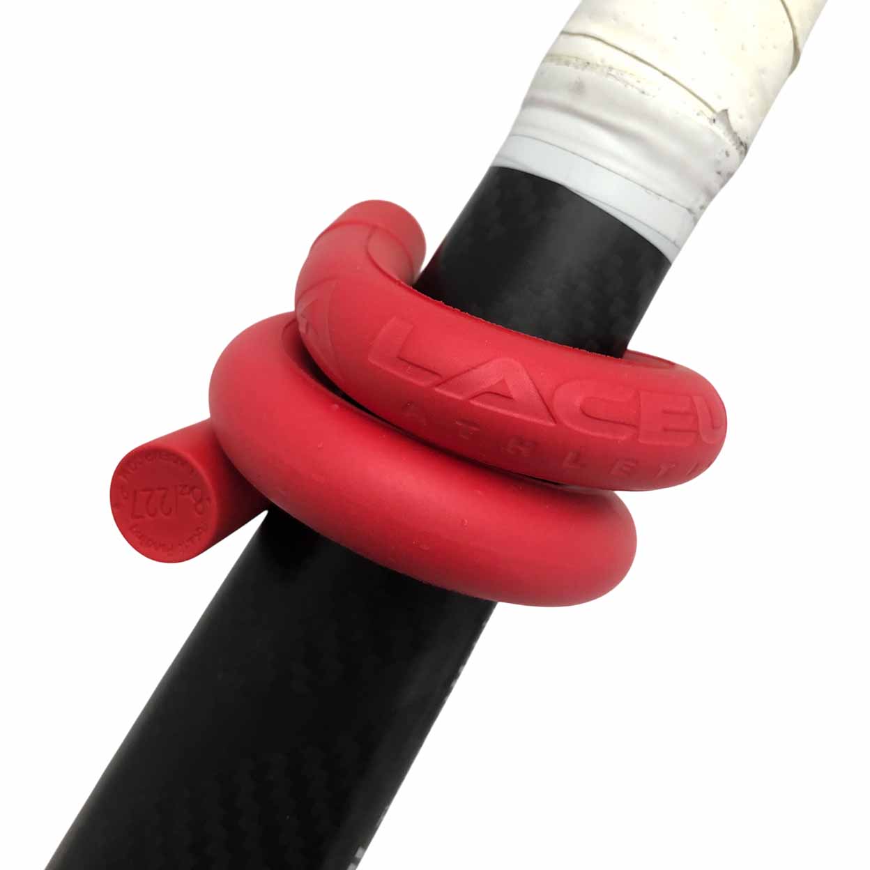 Red lace up weighted band wrapped around the shaft of a back field hockey stick with white grip.