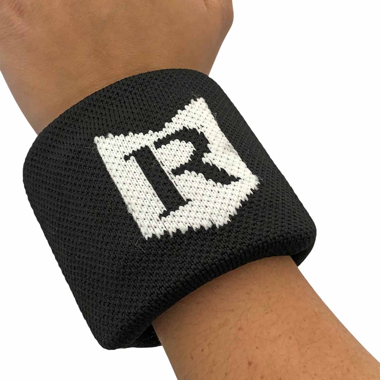 Black wristband with a white logo on a person's wrist against a white background
