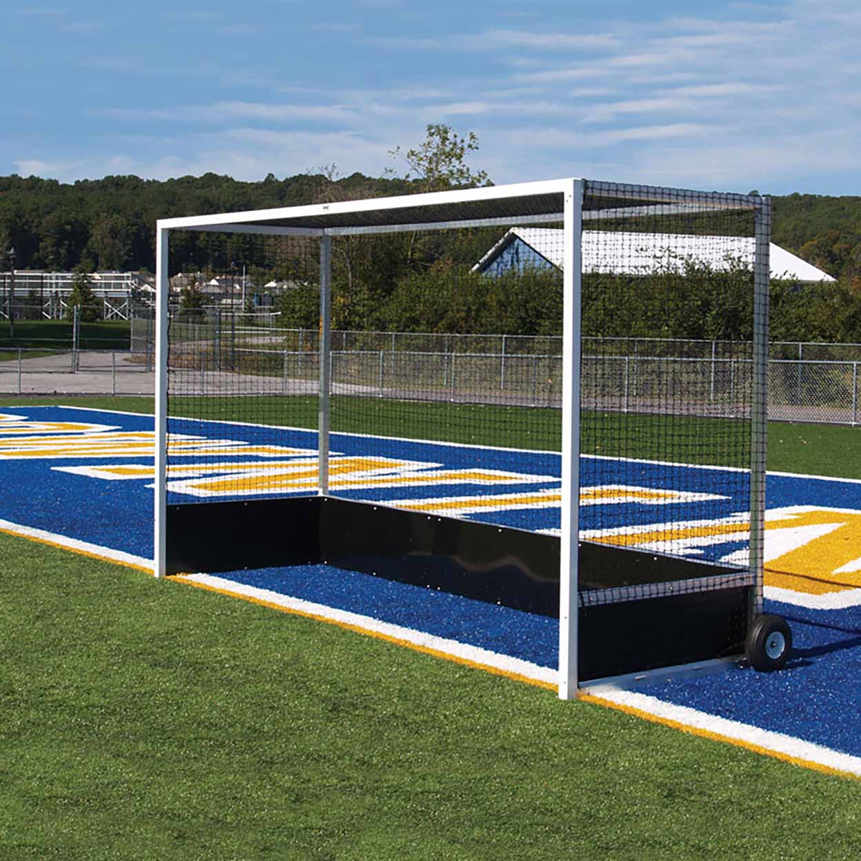 Portable sports training net on a sports field with blue and yellow markings