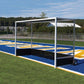 Portable sports training net on a sports field with blue and yellow markings