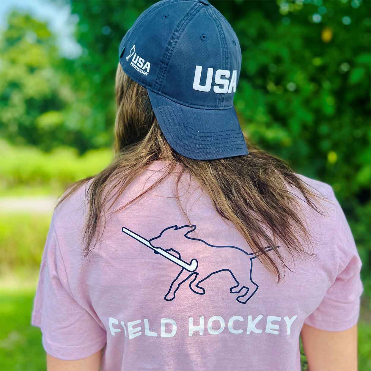 Model wearing the pink Field Hockey Dog Tee and hat