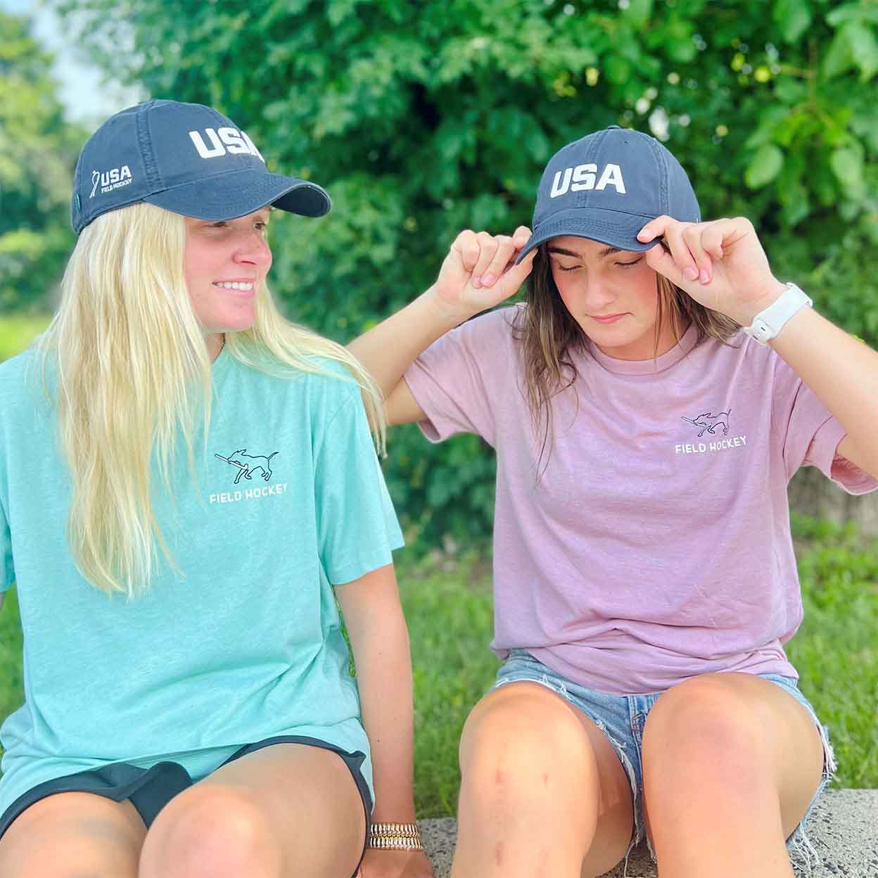 two models wearing the Field Hockey Dog Tee and hat
