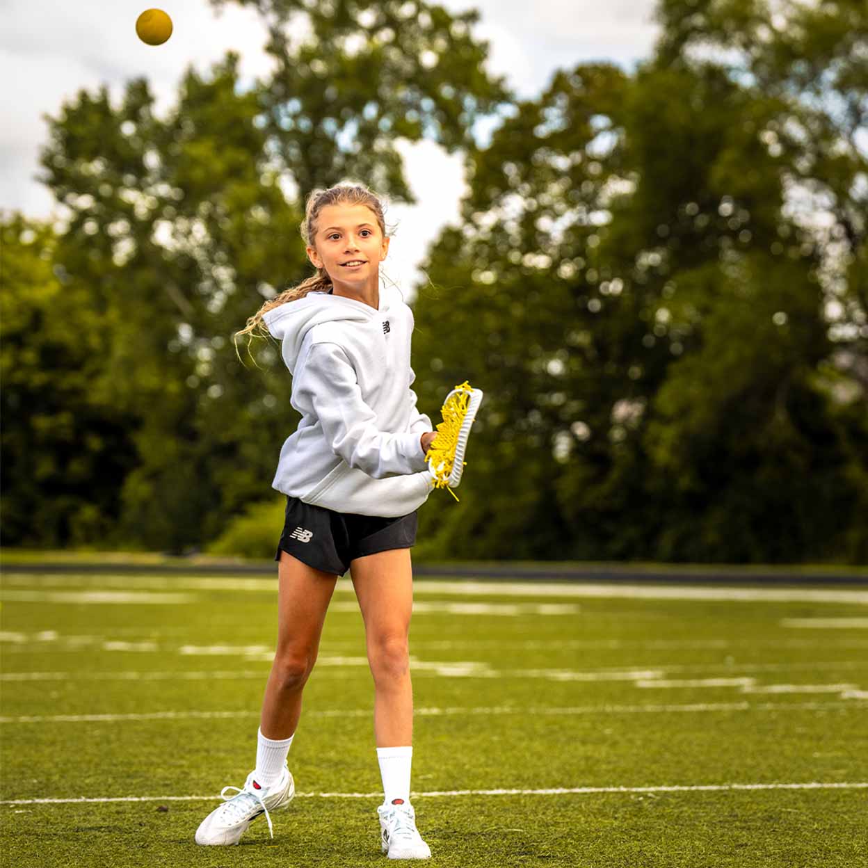 Player using the white and yellow Brine Krown Complete Lacrosse Stick.