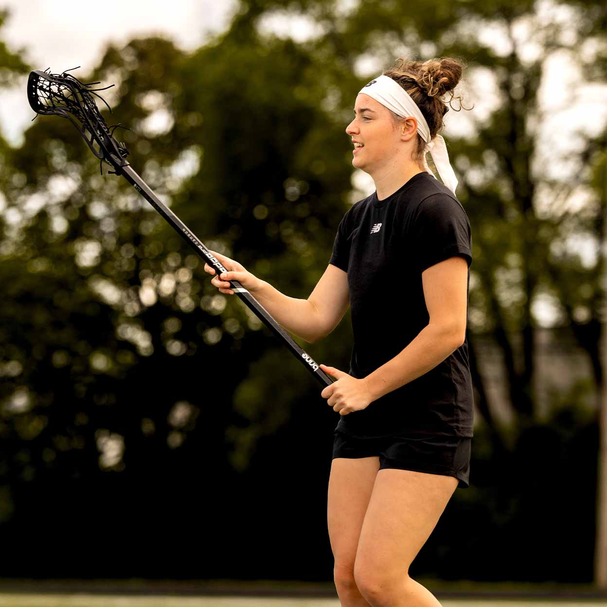 Player using the black Brine Krown Pro Complete Lacrosse Stick