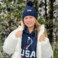 Girl in a winter coat wearing a USA Field Hockey Textured Cuff Beanie.