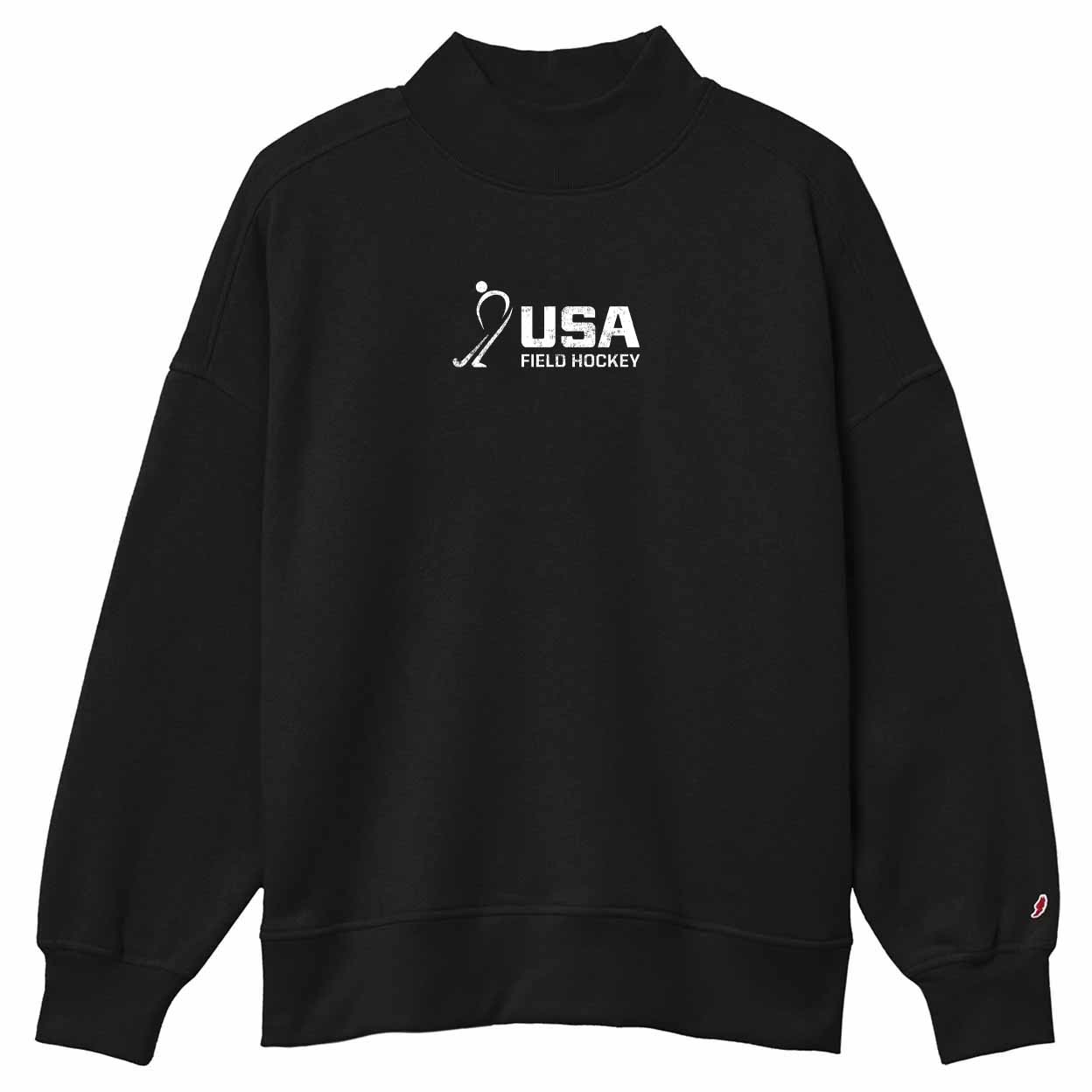 A black crewneck sweatshirt featuring a distressed white 'USA FIELD HOCKEY' graphic printed on the chest, with a small red and white logo on the left sleeve cuff.