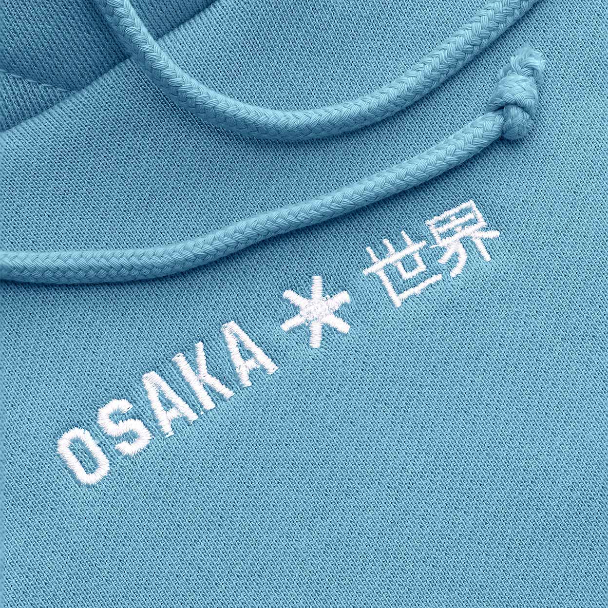 Blue hoodie with 'OSAKA * 世界' text on a close-up of the drawstring.
