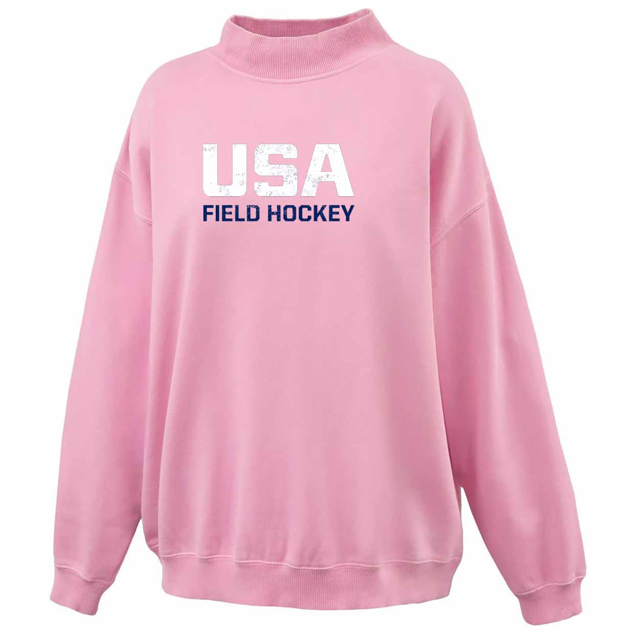 A pink crewneck sweatshirt featuring 'USA FIELD HOCKEY' printed on the chest in distressed white and navy blue lettering, shown against a plain white background.