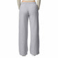 Gray sweatpants worn by a person on a white background