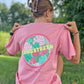 Person wearing a pink t-shirt with 'LONGSTRETH Spring City, PA' design outdoors.