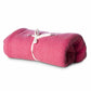 Rolled-up red blanket with a white drawstring on a white background