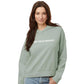 Woman wearing a sage green hooded sweatshirt with 