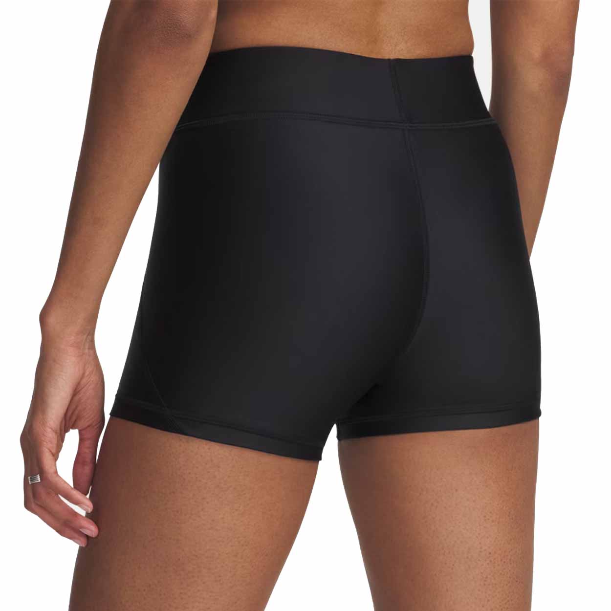 Black athletic shorts worn by a person on a white background