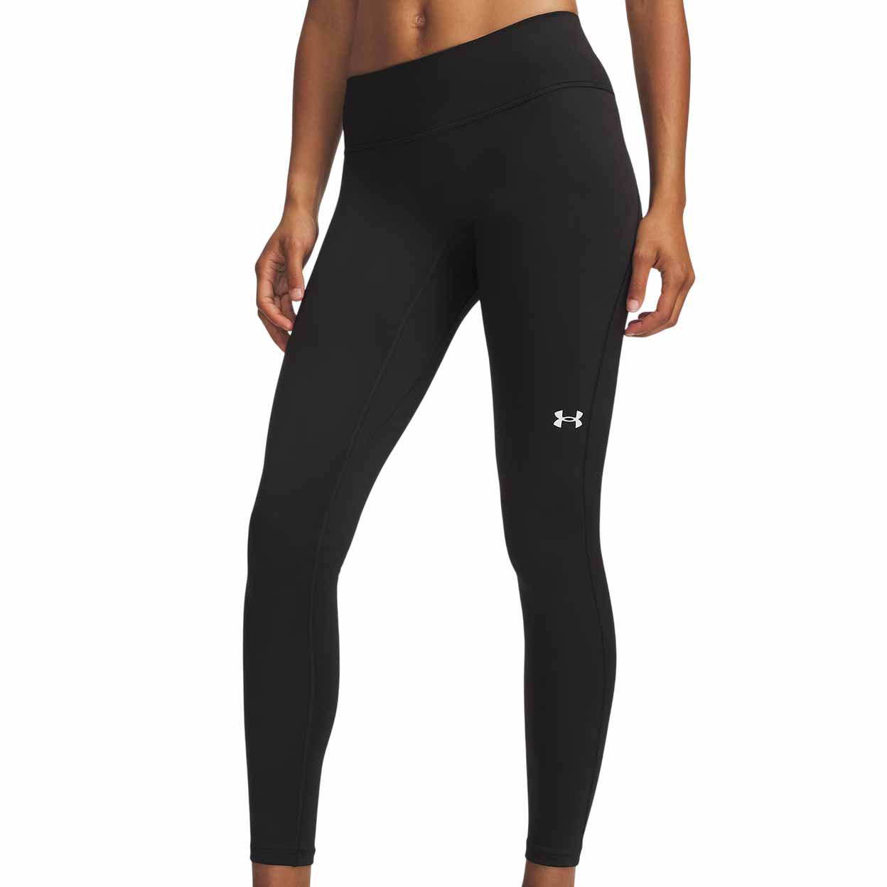A person wearing black Under Armour leggings with a white logo on the left thigh.