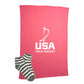 Pink blanket with USA Field Hockey logo and a pair of striped socks on a white background