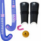 A field hockey kit including two blue and purple GRYPHON brand hockey sticks, black shin guards with white trim, a pink mouthguard, and a yellow hockey ball on a white background.