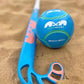Blue and pink beach hockey stick and ball on sand