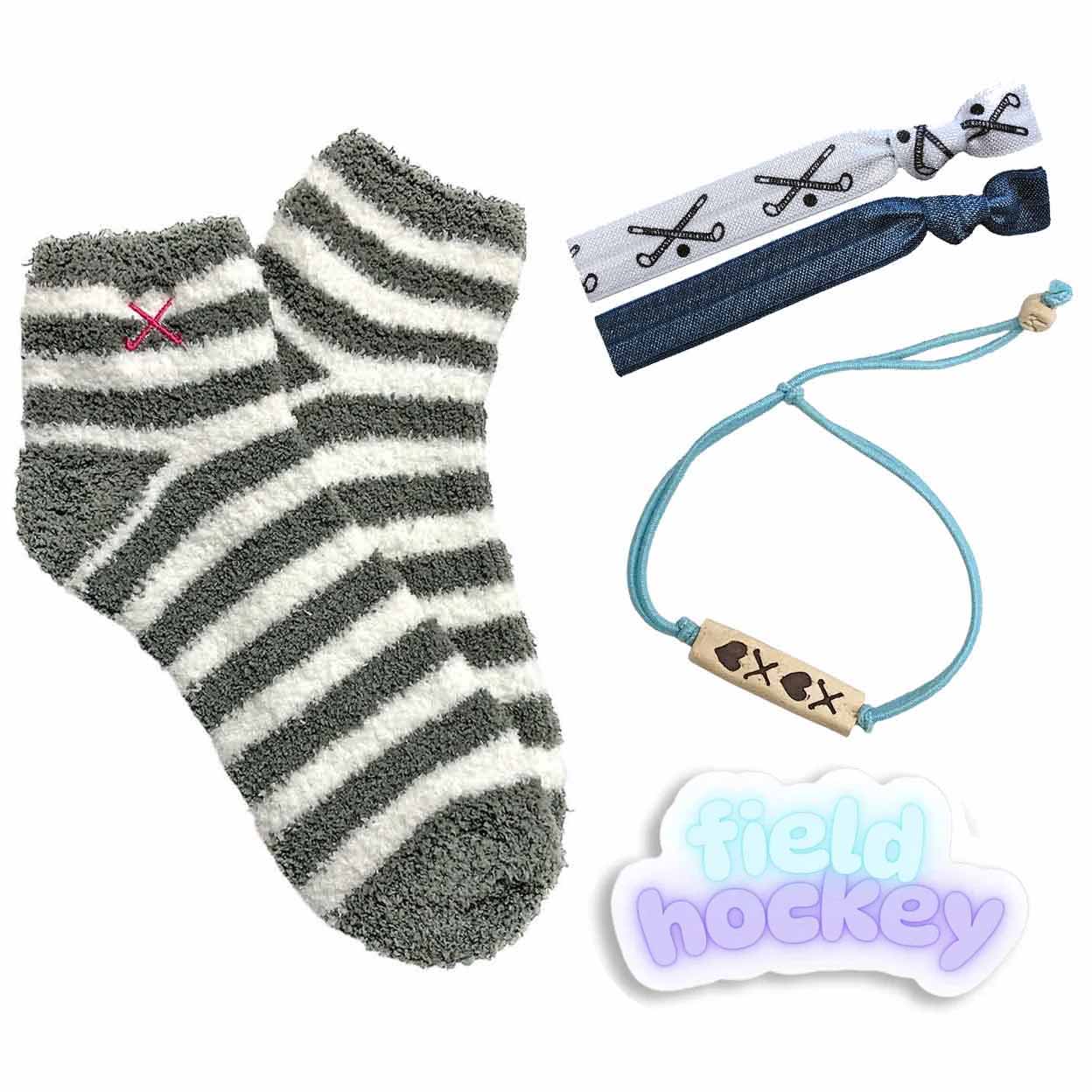 Striped sock, hair ties, bracelet, and 'field hockey' sticker on a white background