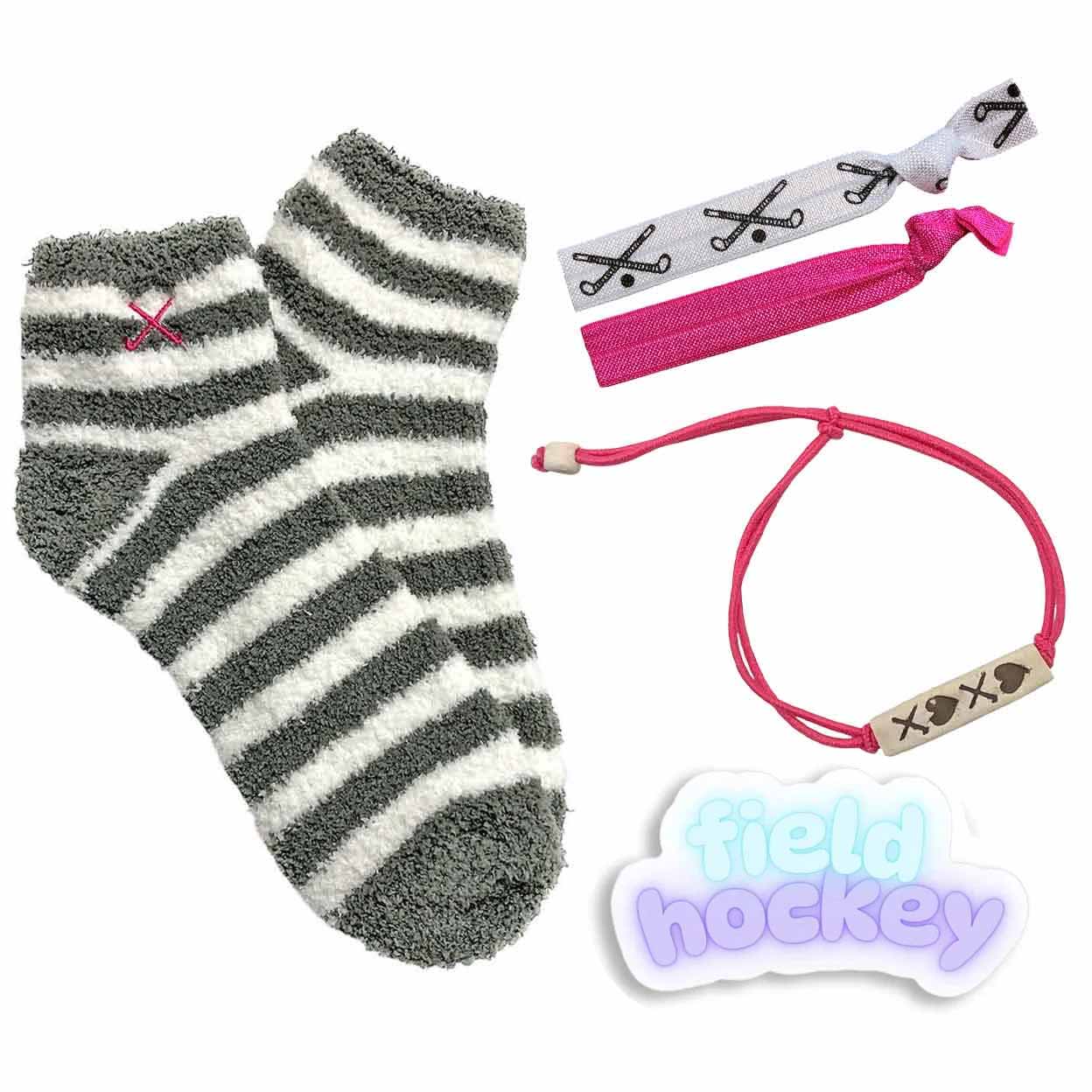 Gray and white striped sock with pink and black hair ties and a 'field hockey' sticker on a white background