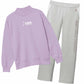 A two-piece sweatshirt and sweatpants set from USA Field Hockey. The sweatshirt is lavender purple with a white USA Field Hockey logo on the chest, and the matching sweatpants are light gray with vertical gray lettering on the left leg.
