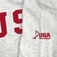 Detail of the sleeve embroidery on the grey sweatshirt