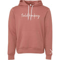 front of the pink Field Hockey Unisex Pullover Hooded Sweatshirt with field hockey script across the chest.